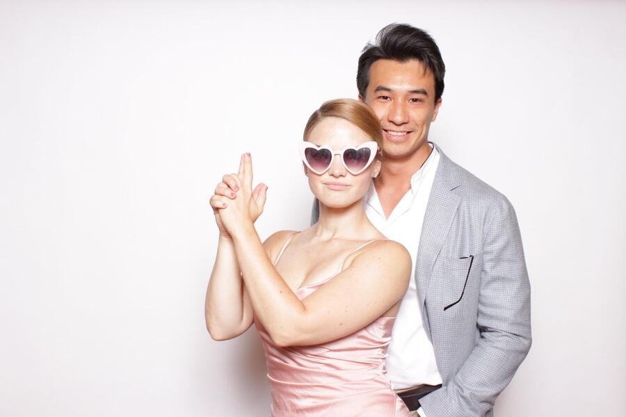 A couple at a wedding photo booth