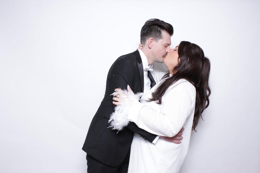 Couple at a wedding photo booth