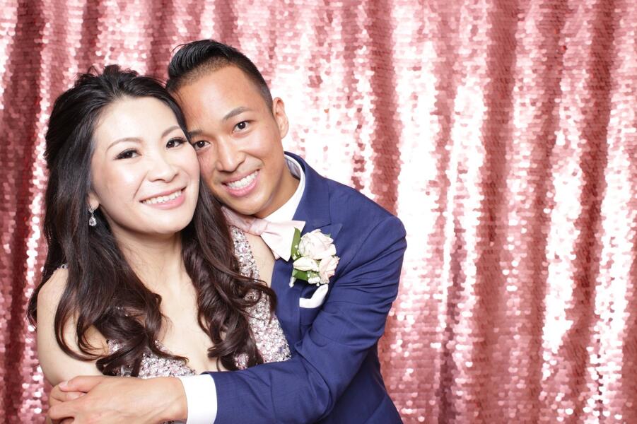 Couple at a pink sequin backdrop