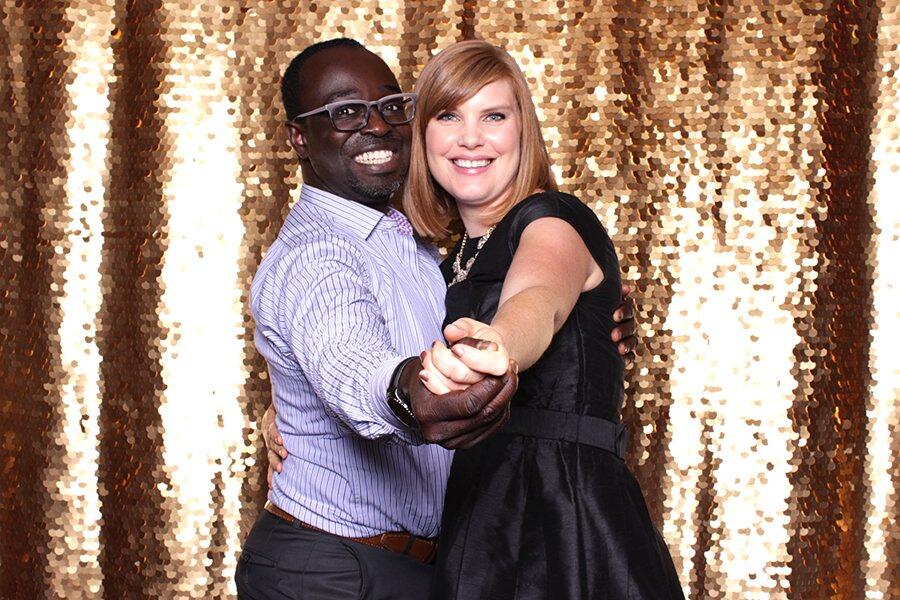 Couple at a gold sequin backdrop