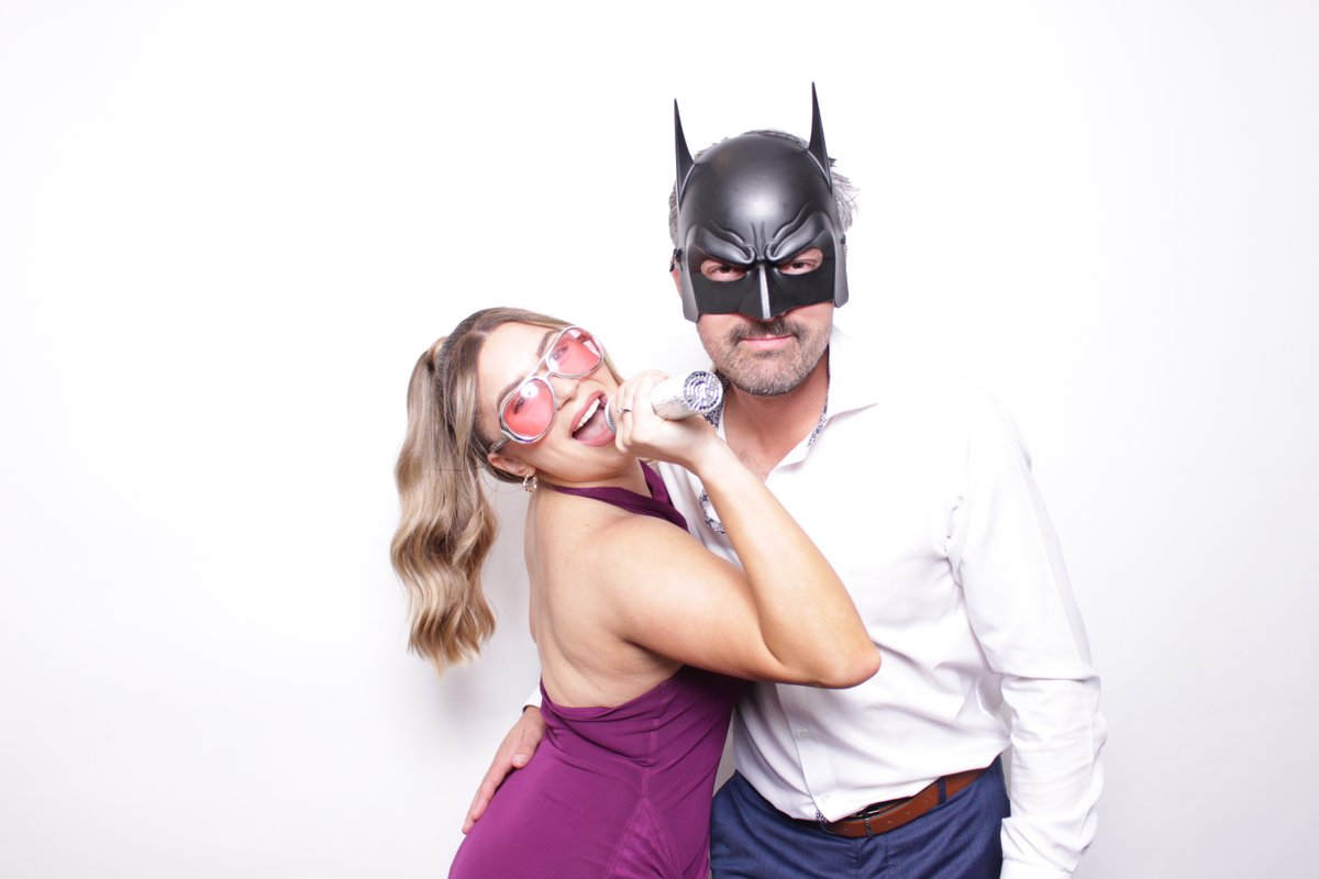 Guests having fun with props at a wedding photo booth