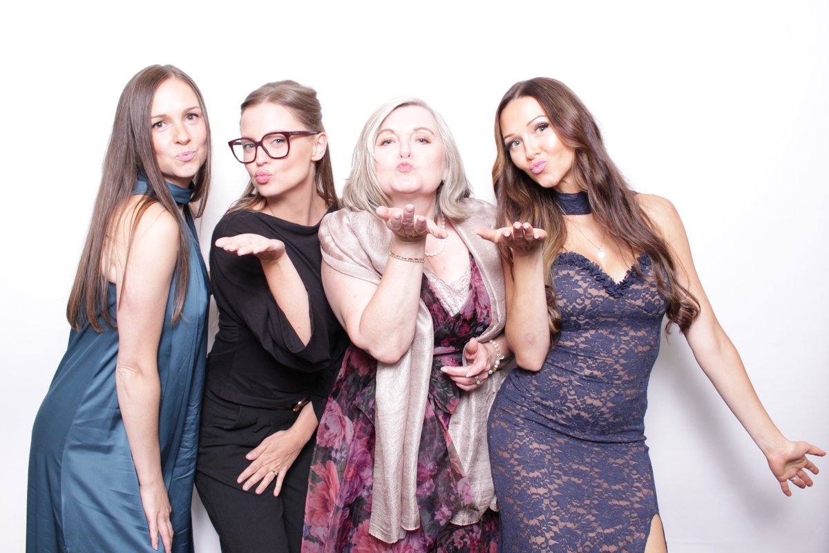 Guests blowing kisses at a photo booth