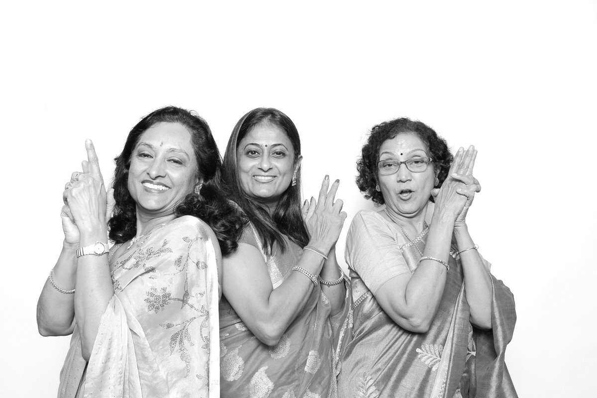 Guests posing at a wedding photo booth