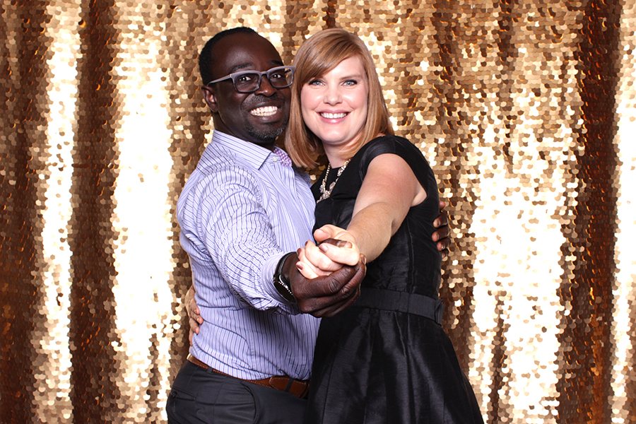 Couple at a gold sequin backdrop