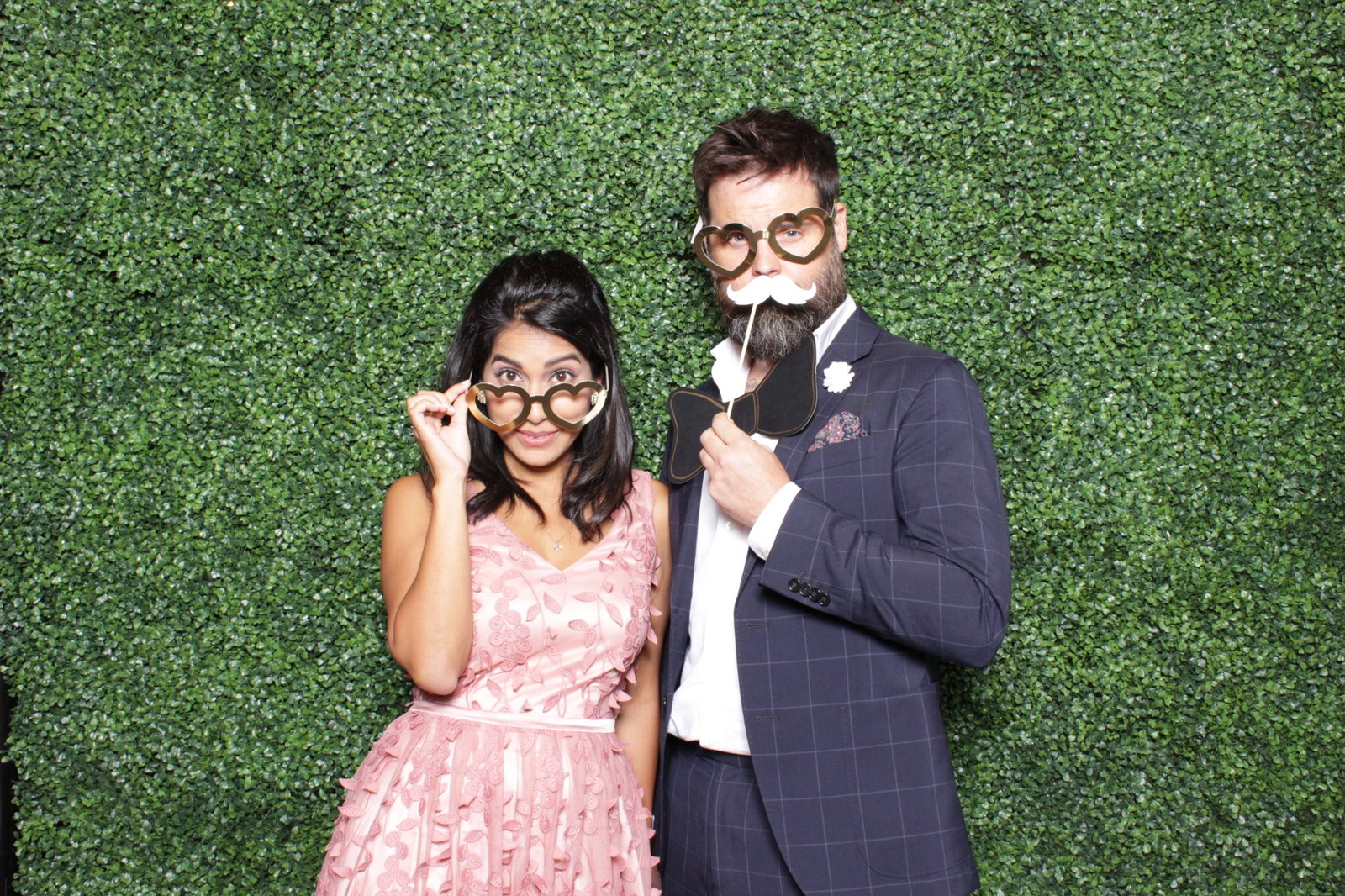 Couple at a greenery wall